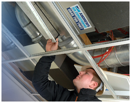 Andrews Air conditioning engineer looking into ceiling system