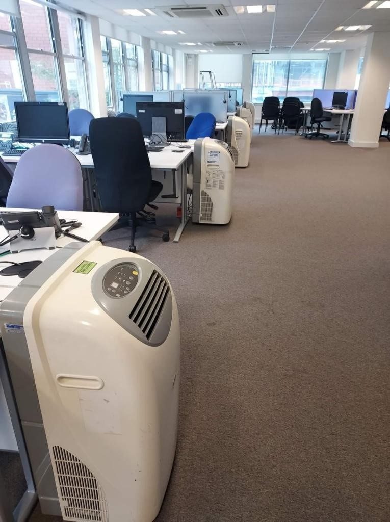 Site survey by Andrews Sykes expert to plan cooling during student Clearing Engineer assessing university building for temporary air conditioning installation
