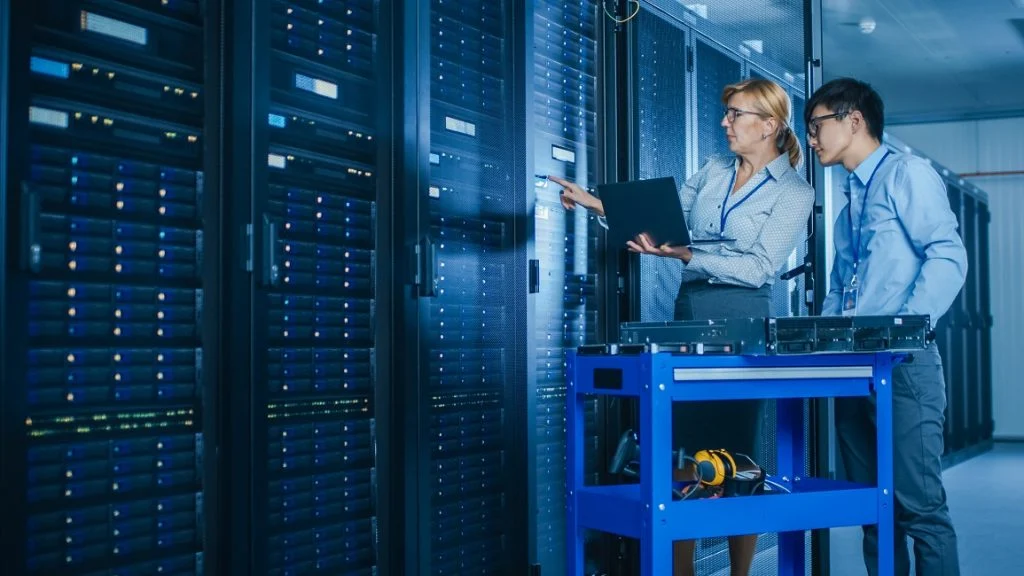 CDATA[Andrews Chiller Hire was recently contacted by a prominent facilities manager looking to prevent a major client’s data centre from overheating. Our customer was aware that their chillers and condensers were no longer performing as expected, meaning a temporary hire solution was required to allow planned repairs to be carried out.
The client was looking to decommission all three of their chillers over a period of two days but could not have less than two units operating at any given time. This precise requirement necessitated that a team of Andrews engineers worked extremely closely with the site’s fitting team to ensure that sufficient cooling capacities were constantly available during peak loads.
Our response was to supply three 750kW chiller units – each with their own temporary pipework and 150-metre cable runs – and these were installed one at a time. The intricate nature of this arrangement meant that our engineers were working until late at night, which was greatly appreciated by the FM company.
Although the chiller rental was prearranged to allow for critical maintenance, there was still potential for disaster to strike should the data centre have gone offline at any point. The quick response and constant presence of our engineers on site during the changeover was greatly reassuring for the customer and provided peace of mind during a very delicate project. Thankfully, we were able to tailor an installation to suit the defined needs of our customer and prevent an outage that could have permanently lost information relating to millions of people in the UK.
![