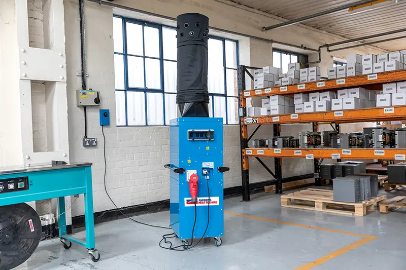 The Andrews Heat for Hire DE95 360 portable electric heater in operation inside a warehouse, connected and ready for use.