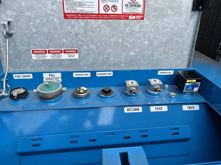 Fuel tank setup with feed, return, and emergency vent connections plus a telemetry monitoring device.