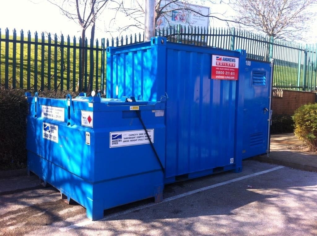 Engineer inspecting commercial boiler for common faults like leaks, noise, or low pressure