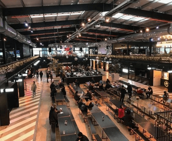 Andrews Air Conditioning technician delivering unit for shop cooling installation in summer