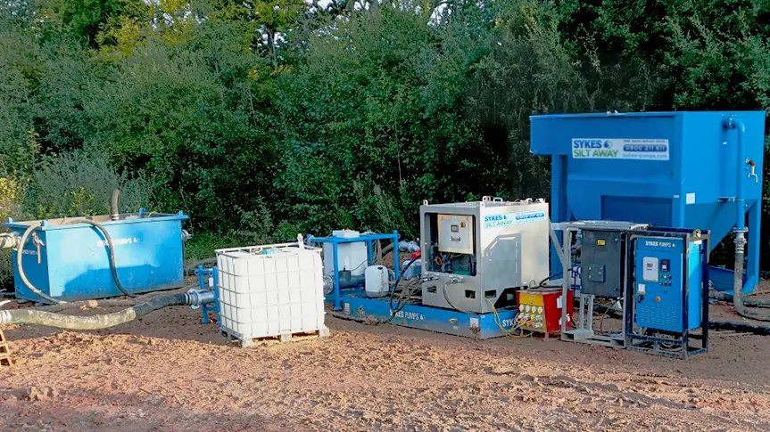 Sykes Pumps Silt Away system with chemical dosing and monitoring equipment used for lake dewatering and water treatment in a West Sussex quarry.
